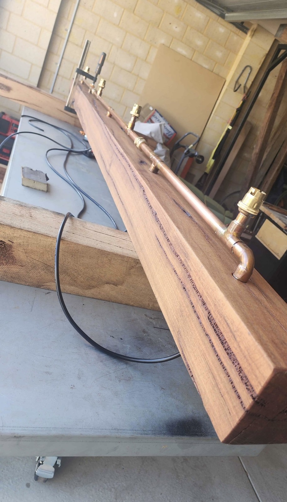 Handcrafted timber and copper light fitting built on site