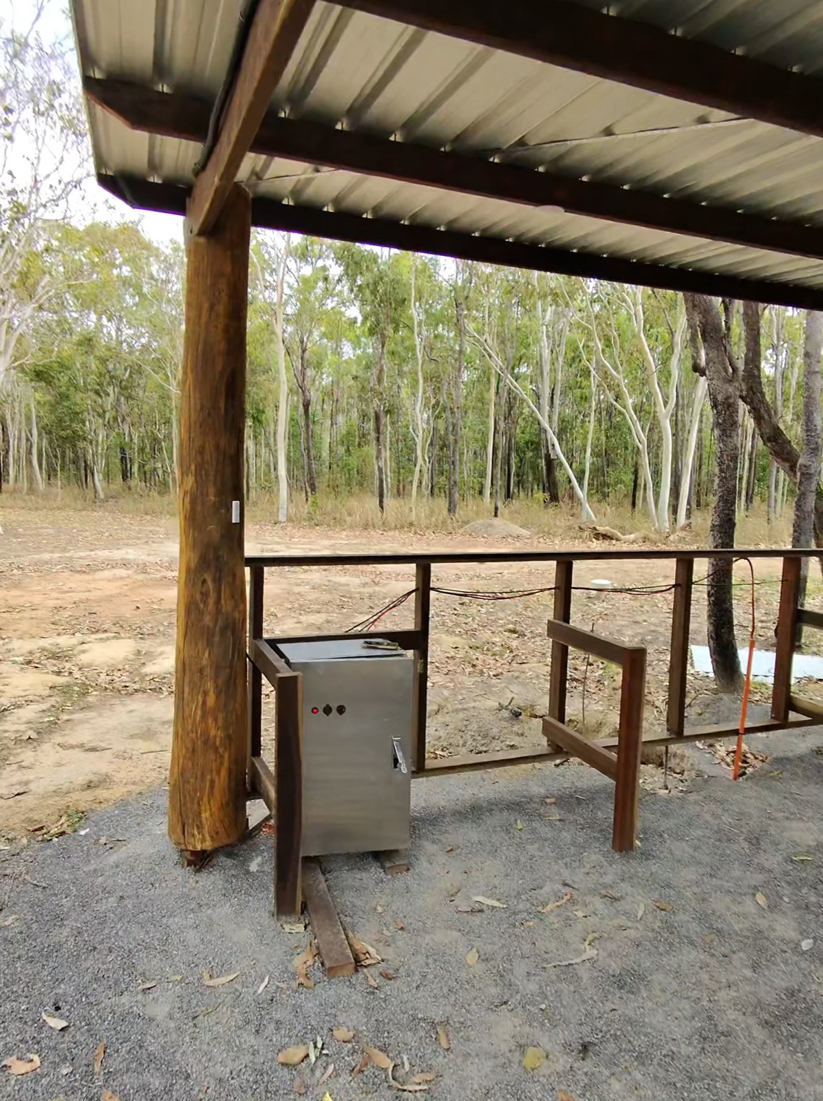 Installed power distribution box under a bush shed